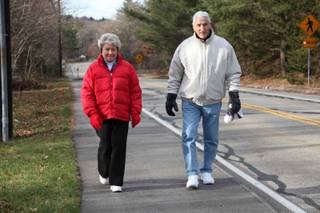 Cecelia and Frank Colella walk along a street in Foxborough. The 50-year residents say introducing a casino will destroy the character of their town.